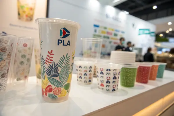 A collection of customized PLA bubble tea cups with different colorful logos.